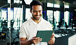Manager, smile and tablet with man in gym for membership application, planning or sign up schedule. Exercise, fitness and tech with health club owner in training facility for agenda or management