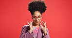Portrait, African woman and fashion in studio with earrings, glasses and trendy clothes. Proud, female person and positive attitude with jewellery, stylish outfit and accessories on red background
