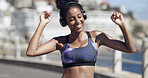 Woman, dancing and headphones for fitness in city for fun, listening to music and exercise podcast. Smile, African person and moving rhythm, workout playlist and sports training of marathon practice