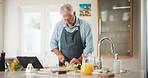 Mature man, tablet and meal prep with recipe tutorial, method or online guide in home. Learning, instructions and person in kitchen with lunch ingredients, diet and cooking steps for web blog