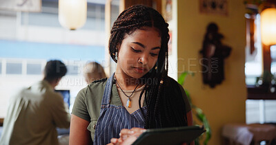 Buy stock photo Woman, waitress and typing with tablet at cafe for inventory, checklist or review at restaurant. Person, barista and click with tech, application and report for stock, menu or services at coffee shop