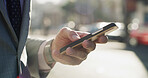 Business person, hands and scroll with smartphone in city for chat, online research and text message on street. Travel, professional and phone in urban town for checking schedule on morning commute