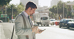 Businessman, coffee and scroll with phone in city for chat, online research and text message on street. Travel, professional and smartphone in urban town for checking schedule on morning commute