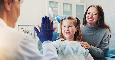 Buy stock photo Child, dentist and high five for oral hygiene or teeth health with advice from orthodontist. Happy girl, family or woman in clinic for dental care, wellness and success of brave kid at consultation