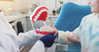 Buy stock photo Hands, kid and dentist with mouth model for medical check, teeth hygiene or dental health. Tooth decay, healthcare procedure and teaching child patient in clinic for oral care, advice or plastic mold