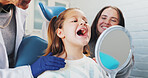 Happy girl, mother and dentist with mirror for tooth implant, filler or veneers at clinic. Child, kid or open mouth with orthodontist or reflection for teeth checkup, surgery or oral and gum care