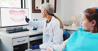 Buy stock photo Child, teaching and dentist with teeth on screen for help, surgery information or diagnosis. Explain, orthodontist and mature woman in practice for dental implant, advice or tooth alignment procedure