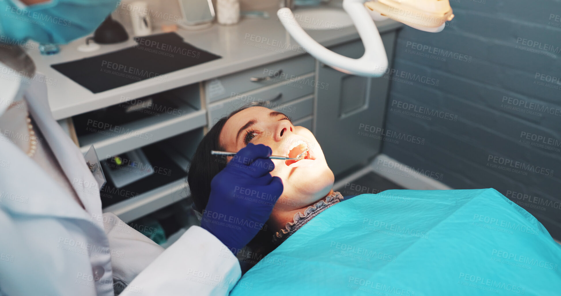 Buy stock photo Dentist, patient and consultation in office, oral health and wellness with equipment. People, medical service and woman in chair, open mouth and dental hygiene with cavity examination and procedure