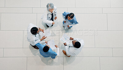 Buy stock photo Doctor, medical team and meeting with documents above for healthcare development or mission. Top view, group or health employees with paperwork in huddle for progress or performance at hospital