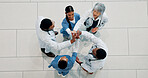Happy, doctor and group with smile, high five or support for achievement in hospital and healthcare. Celebration, medical professional and gesture for success in clinic, win and victory for team