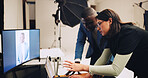 Computer, photographer and people in studio talking with results for editing, selection and process. Photography, creative and woman with male model on tech for post production, planning and design
