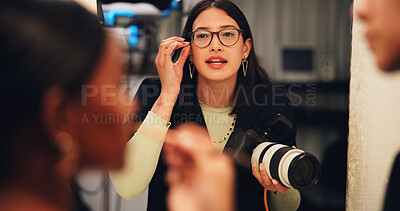 Buy stock photo Woman, photographer and glasses with model for direction, instructions or production in studio. Female person, director or producer with camera, makeup artist or discussion on set for preparation