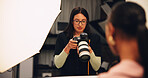 Woman, photographer and check camera in studio of photoshoot results, catalog and review selection. Female person, equipment and backstage of lens focus, editing picture and filming production on set