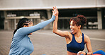 Fitness, workout and women with high five in city for exercise success, teamwork or performance. Athlete, friends and excited with celebration outdoor for wellness goals, training progress or support