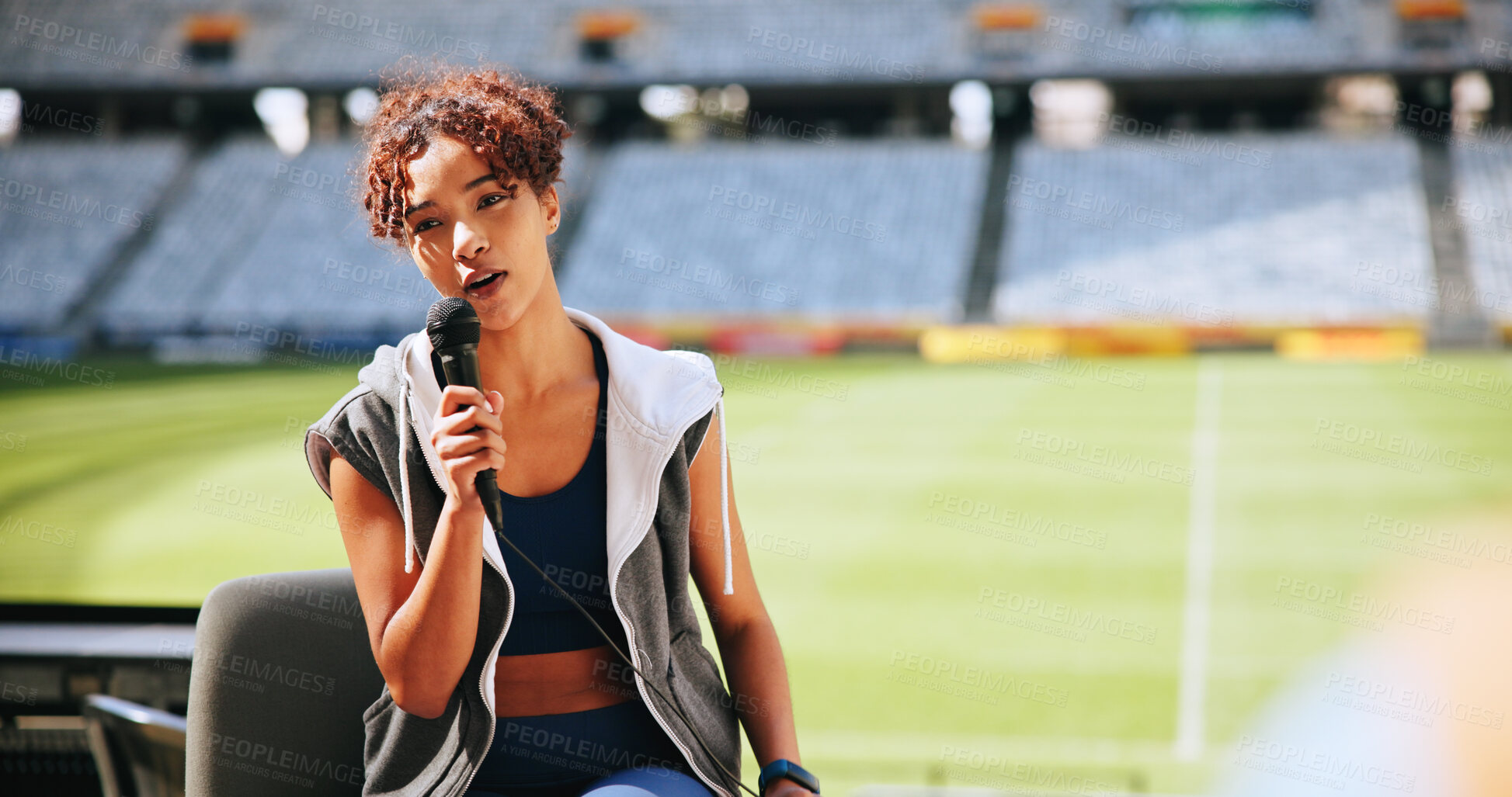 Buy stock photo Athlete, mic and talking in interview at stadium for sports broadcast, media question and space. Public relations, television or woman speaking at press conference for game coverage or fan engagement