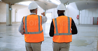 Buy stock photo Men, architect and talk with point at warehouse, engineering and planning for property development. People, back and building inspector with safety check, discussion and review at construction site