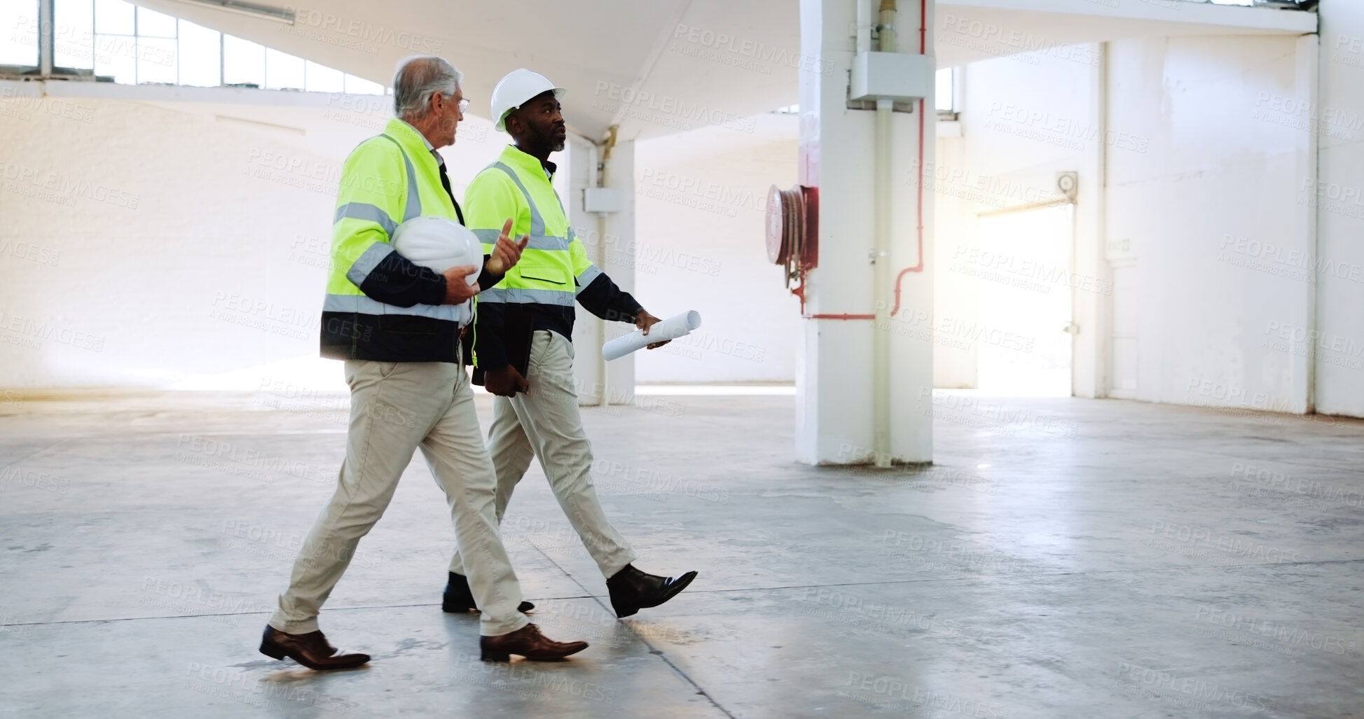 Buy stock photo Men, discussion and construction worker at warehouse, inspection or review for safety check at plant. People, mature mentor and site management with architecture, talk and team at distribution center