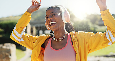 Buy stock photo Fashion, headphones and black woman dance outdoor with energy, freedom and celebration. Listening to music, excited and dancer at park for hip hop, streaming audio and sound for stylish streetwear