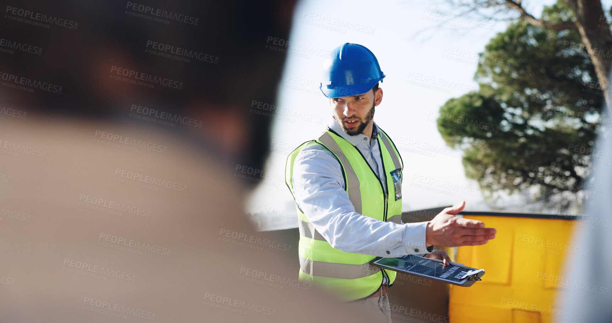 Buy stock photo Engineer, man and clipboard for solar power at construction site with business people, point and talk. Person, technician and outdoor for presentation, renewable energy solution and sustainability