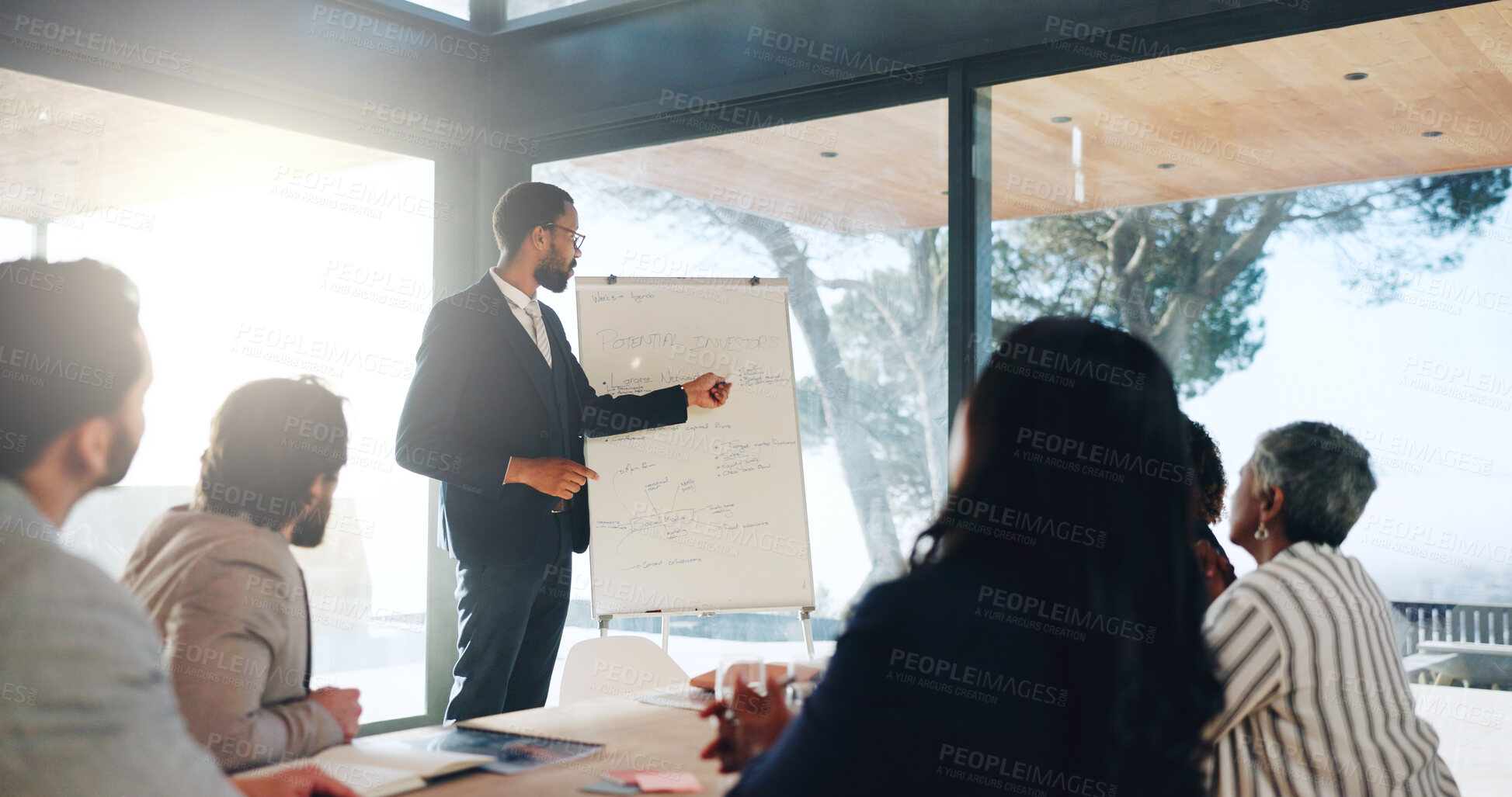 Buy stock photo Presentation, speaker and meeting with business people in office for property investor, planning or team. Real estate portfolio, partnership and discussion with employees in realtor agency for report