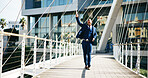 Celebration, hand up and walking with business black man in city for motivation or success. Corporate, deal and victory with winner employee on downtown bridge for achievement, commute or opportunity