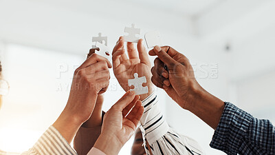 Buy stock photo Business people, hands or team building with jigsaw puzzle for problem solving in workplace. Group, employees or colleagues with connected piece for unity, mission or collaboration together in office