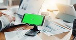 Phone, green screen and person in office for document, finance report and business performance. Mockup space, hand and laptop for financial planning, tax information and investment proposal graphs