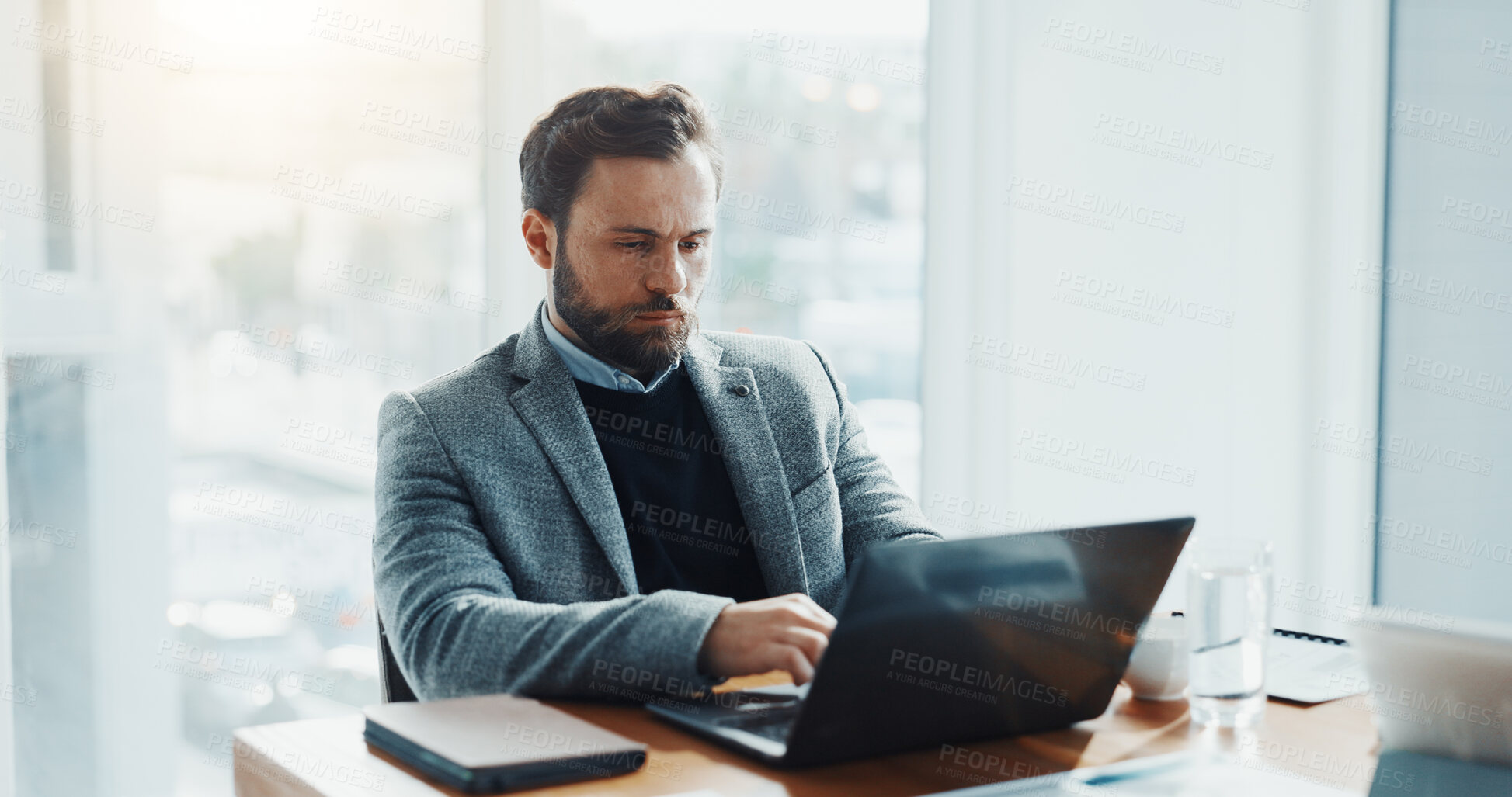 Buy stock photo Online, employee and man with laptop in office, serious and financial analyst with info or research. Planning, investment and person with tech for business growth, reading or digital report on app