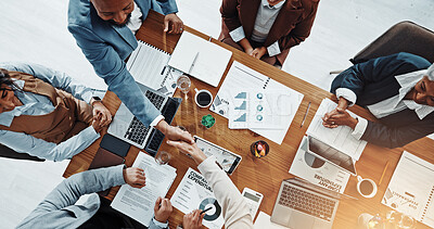 Buy stock photo Deal, people and handshake with client, paperwork and gesture for agreement in boardroom or meeting. Colleagues, collaboration or shaking hands for opportunity in office, above and success of merger