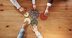 Business people, hands or cogs with gears for team building or problem solving above. Top view, group or employees with wheel mesh for cognitive or critical thinking together on wooden table or space