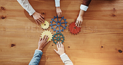 Buy stock photo Business people, hands or cogs with gears for team building or problem solving. Top view, group or employees with wheel mesh for cognitive or critical thinking together on wooden table or space