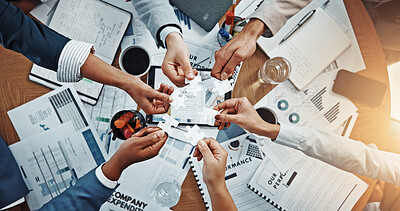 Buy stock photo Hands, puzzle and above at meeting for finance, documents and team with problem solving at office. Business people, group and circle with link, solution or synergy with jigsaw for revenue at company