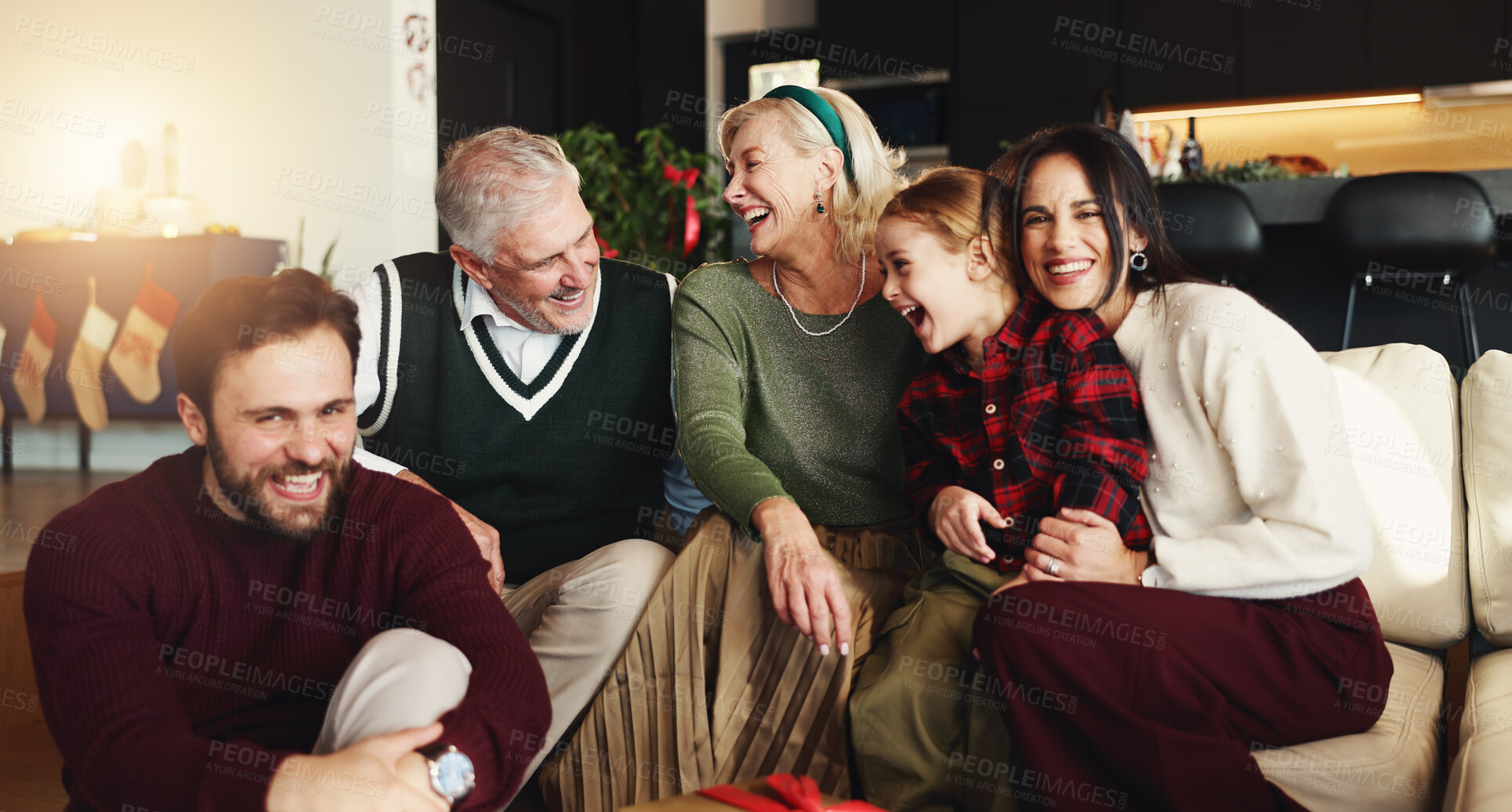 Buy stock photo Happy, big family and home with laugh for christmas celebration, bonding or funny joke together. Grandparents, parents and child with smile in joy on sofa for humor, comedy or festive party in house