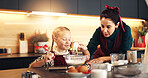Mom, girl and water with flour at Christmas with cooking, teaching and measuring cup for cookies in home. People, mother and daughter in kitchen, learning and guide for baking at xmas in family house
