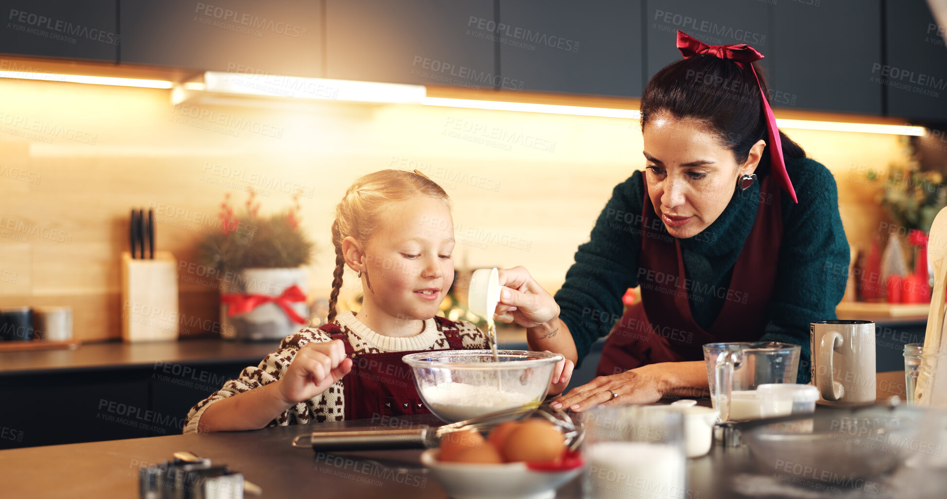 Buy stock photo Mom, girl and baking on Christmas with teaching, smile or measuring cup for festive cookies in home. People, mother and daughter in kitchen, happy or learning guide for xmas cooking in family house