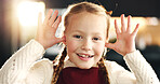 Happy girl, portrait and funny face with humor for playful expression or christmas holiday in home. Child, kid or youth with smile, silly or goofy emotion for comedy, joke or festive mood in house