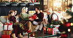 Grandparents, parents and child with gift for Christmas, festive season and bonding on holiday. Happy family, home and girl with mom, dad and senior people for tradition, celebrate or giving presents