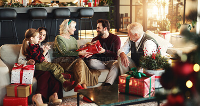 Buy stock photo Grandparents, parents and child with gift for Christmas, festive season and bonding on holiday. Happy family, home and girl with mom, dad and senior people for tradition, celebrate or giving presents