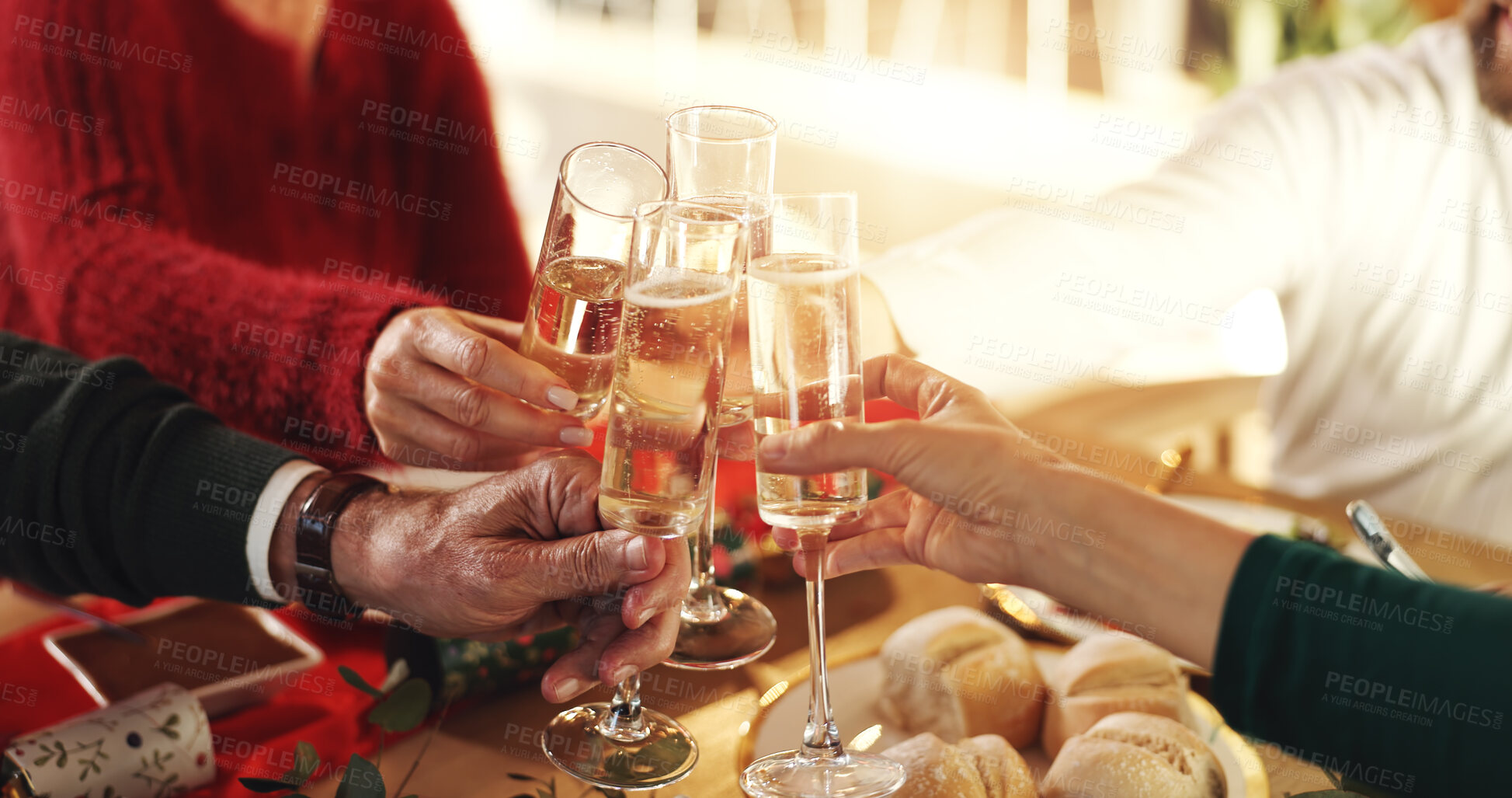 Buy stock photo Family, hands and cheers with champagne glasses for thanksgiving dinner, toast or home feast. People, alcohol or drink with meal for dining celebration, festive holiday or get together in house