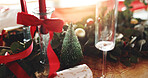 Christmas, decorations and wine glass on table in dining room for festive celebration, event or lunch. Holidays, place setting and tree for thanksgiving with social gathering in December in home.