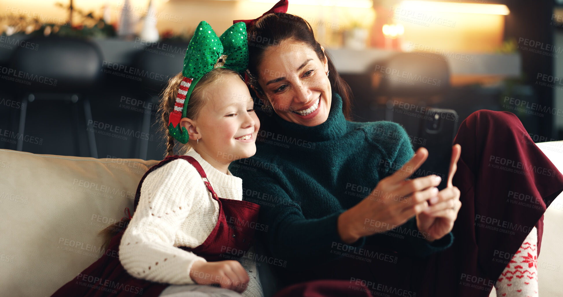 Buy stock photo Christmas selfie, mother and happy child with phone on sofa for festive season, bonding or family smile. Xmas, daughter and mom with tech in home for profile picture, social media or holiday memory