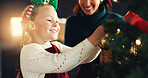 Christmas, decoration or tree with mother and daughter in living room of home for celebration. Creative, event or festive with smile of girl child and happy single parent getting ready in apartment