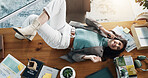 Above, music and smile with woman on desk in office for break, radio streaming or relax. Audio, headphones and entertainment streaming with business employee lying on table in workplace for rest