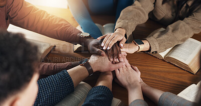 Stack of hands, bible and people by table for unity, solidarity and support at religion study. Trust, top view and prayer group with partnership and collaboration with holy book for worship community