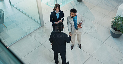 Buy stock photo Handshake, meeting and welcome with business people in lobby of office for agreement from above. B2B, deal and thank you with employee team shaking hands in workplace for hiring or onboarding