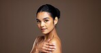 Portrait, beauty and skincare with confident woman in studio for glow, natural aesthetic. Face, shoulder a female model with cosmetics for dermatology, self care or skin health on background space