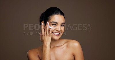Buy stock photo Beauty, portrait and woman with face cream in studio for collagen treatment, hydration and routine. Mockup, person and happy with moisturizer application on brown background for skin glow and retinol
