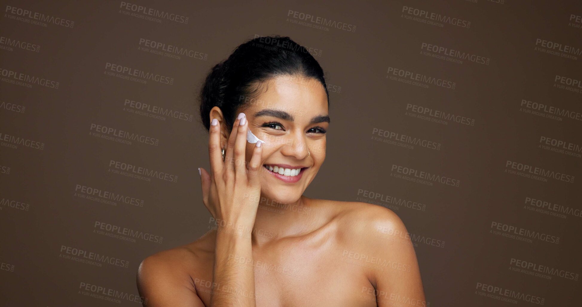 Buy stock photo Beauty, portrait and woman with face cream in studio for collagen treatment, hydration and routine. Mockup, person and happy with moisturizer application on brown background for skin glow and retinol