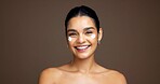 Beauty, portrait and woman with face cream in studio for collagen treatment, hydration and self care. Mockup, person and happy with cosmetics product on brown background for skin glow and moisturizer