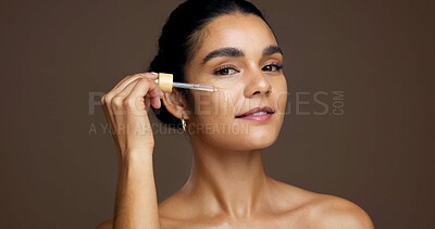Buy stock photo Beauty, portrait and serum with woman in studio for antiaging cosmetics or dermatology treatment. Aesthetic, dropper and smile of model on brown background to apply liquid skincare product to face